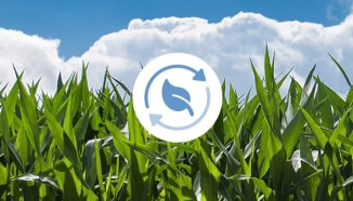 A field with a sustainable sourcing icon over it